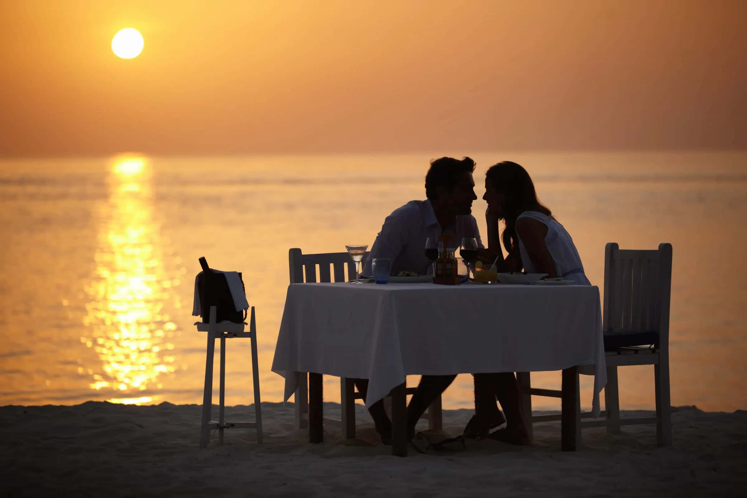 Honeymoon: a romantic dinner for two by the sea at sunset